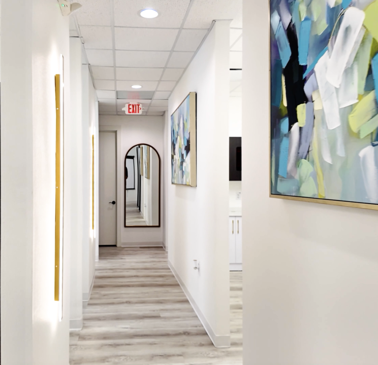 Bright hallway with artwork inside MK Dental Studio in Fulshear, TX